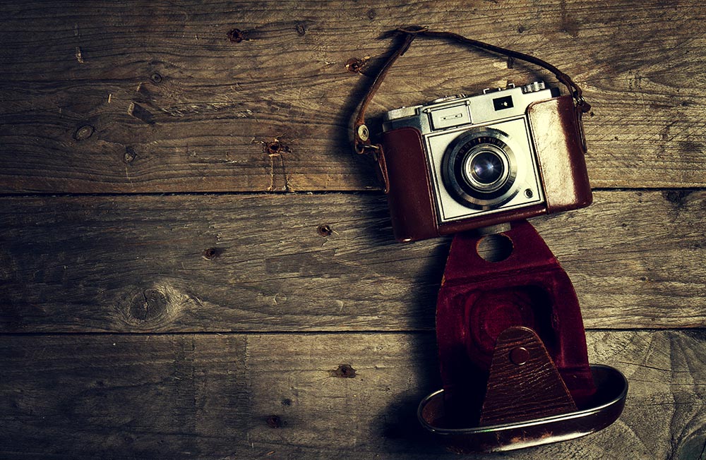 Old Vintage Camera on Dark Wooden Background. Horizontal with Co